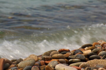 Beach with stone and wave in the background