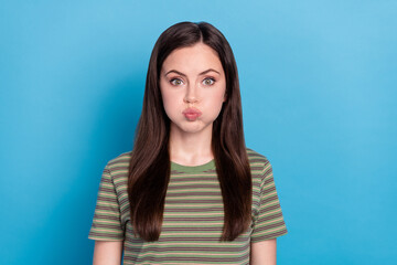 Fototapeta premium Photo of cute millennial brunette lady hold air wear green t-shirt isolated on blue color background