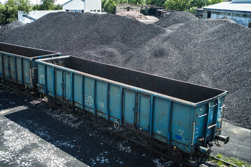empty railway wagon for transportation of coal and coal halide in sunny day