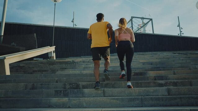 Cinematic video of urban runners athletes training outdoor in a modern part of the city. Concept about sport and healthy lifestyle