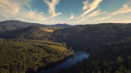Aerial view of the river Ulla crossing a valley covered by lush forests, as it passes through the...
