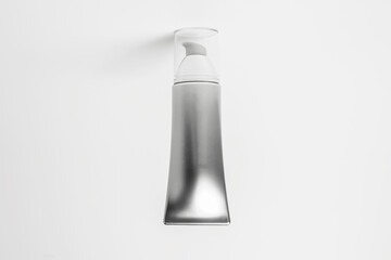 Close-up of cosmetic tube bottle of grey isolated on white background.