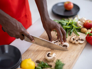 Close-up of person cutting mushrooms