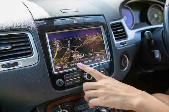 Young�woman using car navigation, close up of hand