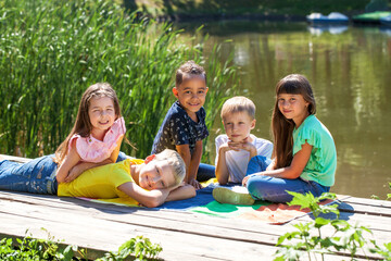 Little girl and boy posing in summer park