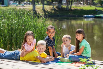 Fototapeta premium Five preschool children posing in a summer park