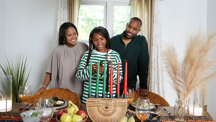 Family with daughter (12-13) lighting kinara candles
