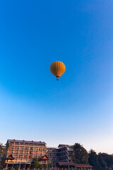 Fototapeta na wymiar A hot air balloon floats over Vang Vieng Province, Laos.