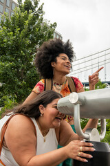 Fototapeta USA, New York City, Two women using telescope for sightseeing obraz