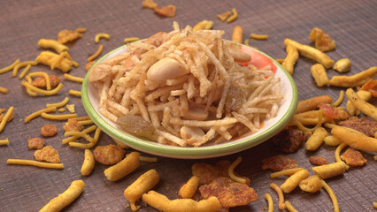 Indian Snacks, Traditional Indian deep fried salty dish called chivda or mixture or farsan made of gram flour and mixed with dry fruits and roasted nuts with salt, pepper, pulses, spice and green peas