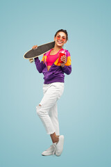 Happy female skater drinking smoothie and smiling in studio