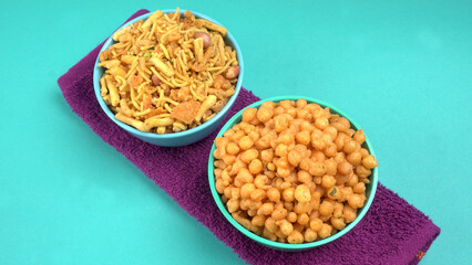 Indian Snacks, Traditional Indian deep fried salty dish called chivda or mixture or farsan made of gram flour and mixed with dry fruits and roasted nuts with salt, pepper, pulses, spice and green peas