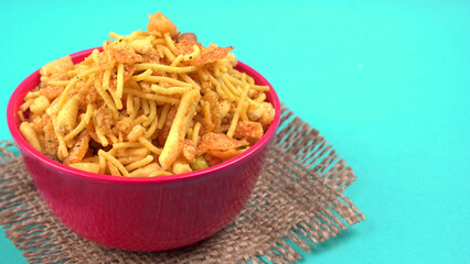 Indian Snacks, Traditional Indian deep fried salty dish called chivda or mixture or farsan made of gram flour and mixed with dry fruits and roasted nuts with salt, pepper, pulses, spice and green peas