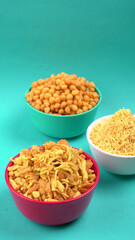 Indian Snacks, Traditional Indian deep fried salty dish called chivda or mixture or farsan made of gram flour and mixed with dry fruits and roasted nuts with salt, pepper, pulses, spice and green peas