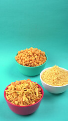 Indian Snacks, Traditional Indian deep fried salty dish called chivda or mixture or farsan made of gram flour and mixed with dry fruits and roasted nuts with salt, pepper, pulses, spice and green peas