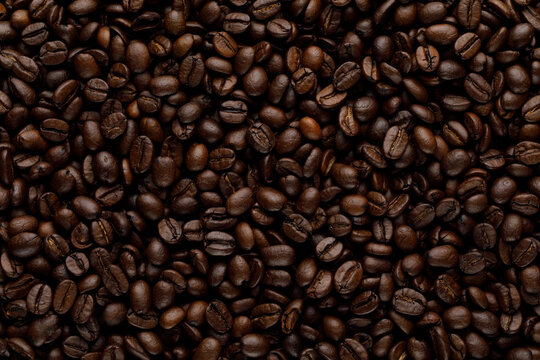 Closeup coffee beans dark background. Whole sead seamless texture