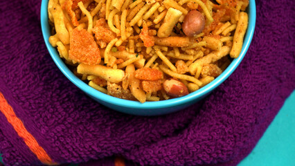 Indian Snacks, Traditional Indian deep fried salty dish called chivda or mixture or farsan made of gram flour and mixed with dry fruits and roasted nuts with salt, pepper, pulses, spice and green peas