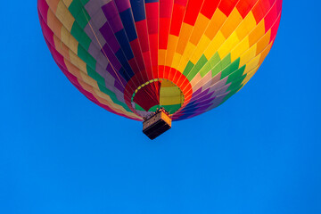 Colorful hot air balloon flying in the bright blue sky