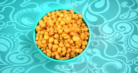 Indian Snacks, Traditional Indian deep fried salty dish called chivda or mixture or farsan made of gram flour and mixed with dry fruits and roasted nuts with salt, pepper, pulses, spice and green peas