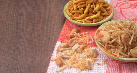 Indian Snacks, Traditional Indian deep fried salty dish called chivda or mixture or farsan made of gram flour and mixed with dry fruits and roasted nuts with salt, pepper, pulses, spice and green peas