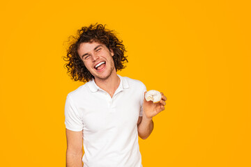 Cheerful man with tasty doughnut
