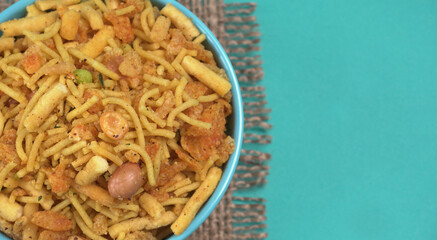 Indian Snacks, Traditional Indian deep fried salty dish called chivda or mixture or farsan made of gram flour and mixed with dry fruits and roasted nuts with salt, pepper, pulses, spice and green peas