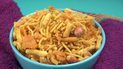 Indian Snacks, Traditional Indian deep fried salty dish called chivda or mixture or farsan made of gram flour and mixed with dry fruits and roasted nuts with salt, pepper, pulses, spice and green peas