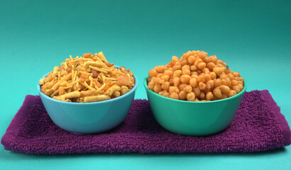 Indian Snacks, Traditional Indian deep fried salty dish called chivda or mixture or farsan made of gram flour and mixed with dry fruits and roasted nuts with salt, pepper, pulses, spice and green peas