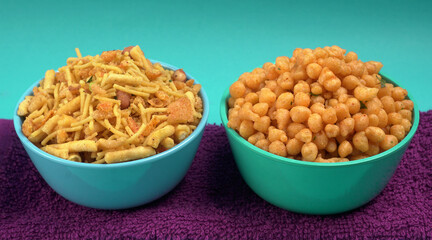 Indian Snacks, Traditional Indian deep fried salty dish called chivda or mixture or farsan made of gram flour and mixed with dry fruits and roasted nuts with salt, pepper, pulses, spice and green peas