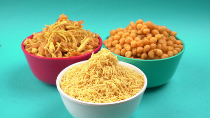 Indian Snacks, Traditional Indian deep fried salty dish called chivda or mixture or farsan made of gram flour and mixed with dry fruits and roasted nuts with salt, pepper, pulses, spice and green peas