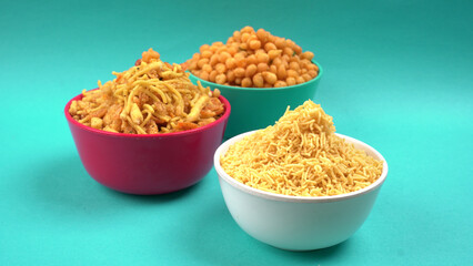 Indian Snacks, Traditional Indian deep fried salty dish called chivda or mixture or farsan made of gram flour and mixed with dry fruits and roasted nuts with salt, pepper, pulses, spice and green peas