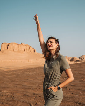Happy woman standing in desert