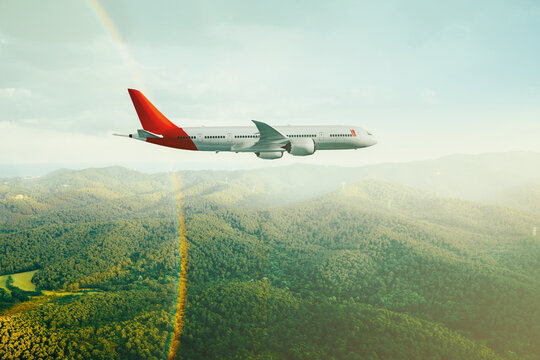 Commercial plane flying over green mountains