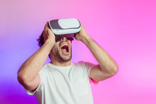 Cheerful man in VR glasses celebrating success