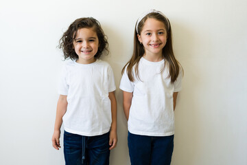 Caucasian kids wearing together their print logo mockup t-shirts