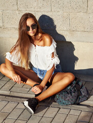 Street portrait of stylish young woman in casual clothes 