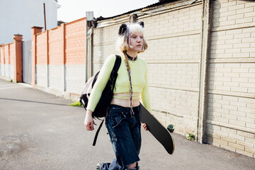 Real beauty no makeup rebel skater woman walking outdoors