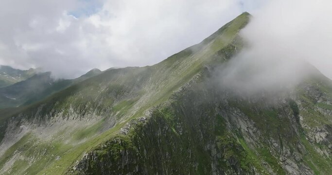 aerial view of moldoveanu peak in clouds with tourists