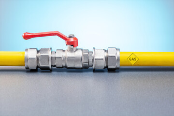 Yellow gas pipe with valve. Gas transportation system. Concept of gas consumption, crisis, price...