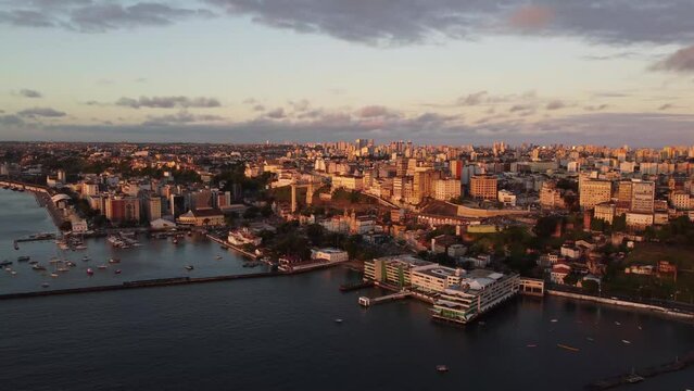 Amazing aerial cinematographic image with orange light of the drone dusk of the capital Salvador in Bahia in coastal metropole