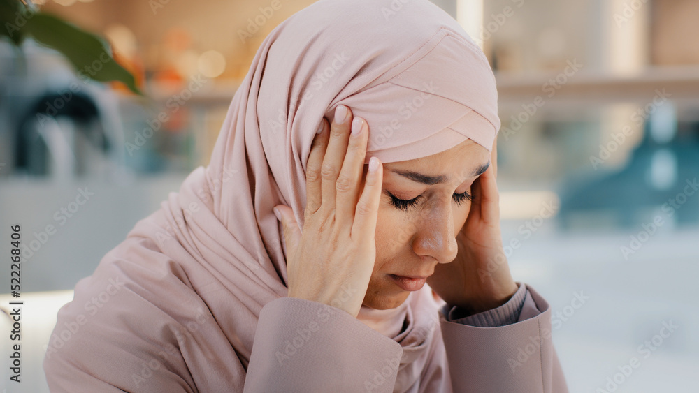 Wall mural close-up upset young woman gets bad news feels stressful anxiety frustrated muslim girl suffers from