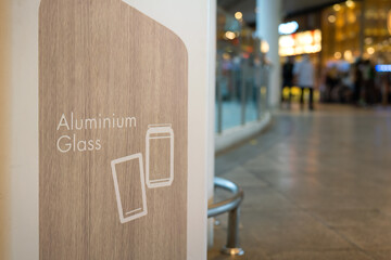 Aluminium and glass wash type icon and text on the wooden surface of luxury rubbish trash. Sign and...