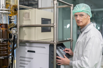 In the cannabis plantation plant engineer routine check the distillation glass syphon tube...