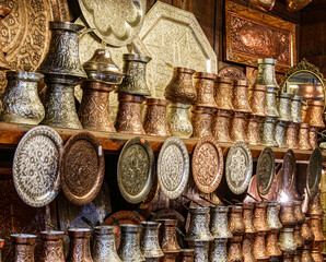 Sarajevo, Bosnia - May 2, 2022 - Copper, silver and brass tableware for sale in shop.