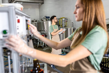 Man and woman working in craft brewery.