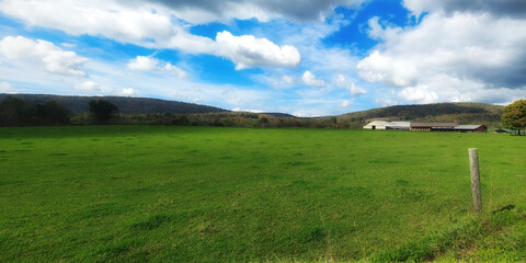A beautiful November morning in Upstate NY.  Open fields with a farm in the background show off the Beauty of NY State.  Bright blue skies and white clouds!