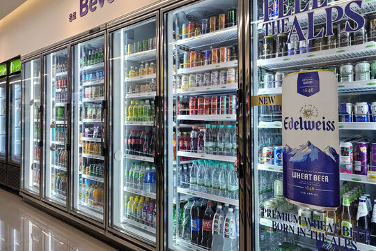 PENANG, MALAYSIA - 9 AUG 2022: Huge fridge with various choice foods and beverages in CU Convenience Store. CU is a South Korean convenience store chain that is operated and owned by BGF Retail.