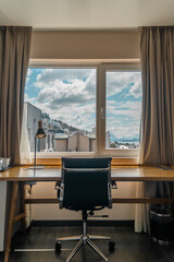 Fototapeta premium room with desk and table for working with mountain views