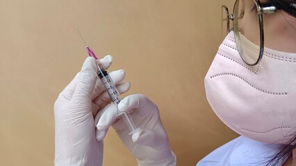 doctor holding syringe