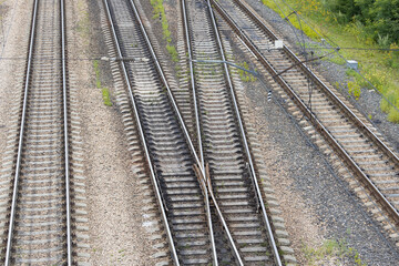 Fototapeta na wymiar Railway tracks interchanges. A railway junction. Crossing parallel railroad tracks. Industrial background. Top view